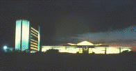 National Library of Medicine complex, looking west from Rockville Pike, illuminated at nighttime (photograph, 8-bit color, GIF87 format, 102 pixels high, 196 pixels wide, 10652 bytes)