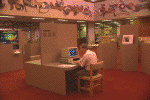 Patron sitting a computer workstation beneath rotunda of the National Library of Medicine (photograph, 8-bit color, GIF87 format, 100 pixels high, 150 pixels wide, 10524 bytes)